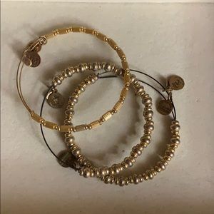 Three piece Alex and Ani gold bangle set